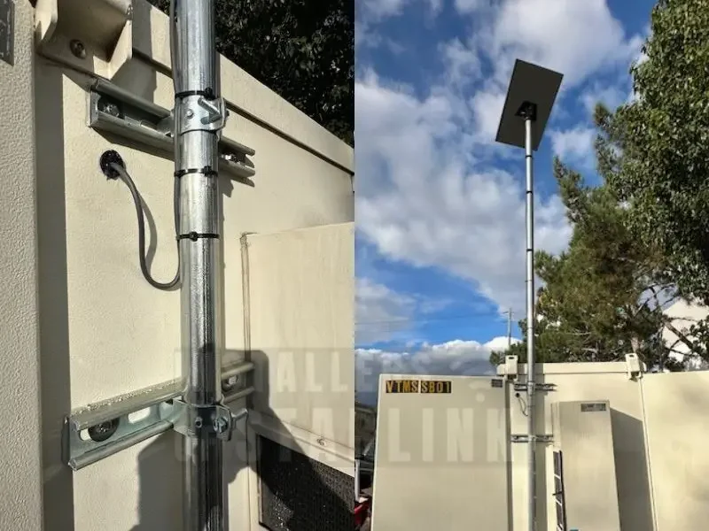 A completed Starlink custom wall mount with extended pole attached to the exterior of a commercial tollbooth done by our installers.
